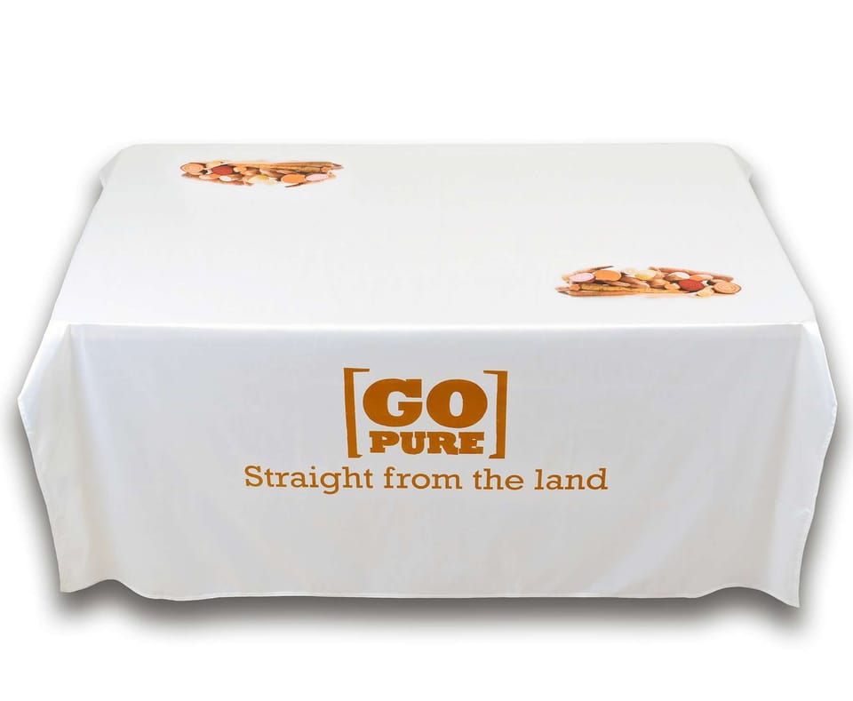Wit bedrukt tafelkleed met logo dat tot op de grond over een kraamtafel valt